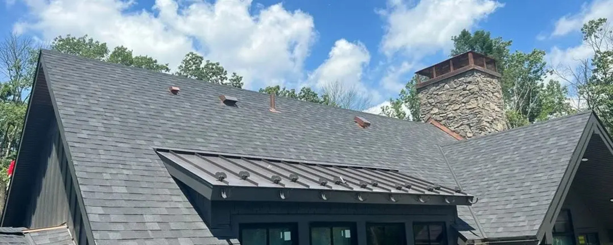Pad-style snow guards installed on a residential standing seam roof.